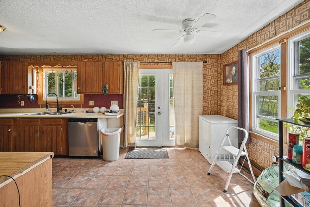 5 Skyline Dr, Chelsea, ME 04330 - kitchen featuring stainless steel dishwasher, a sink, light countertops, a textured ceiling, and ceiling fan