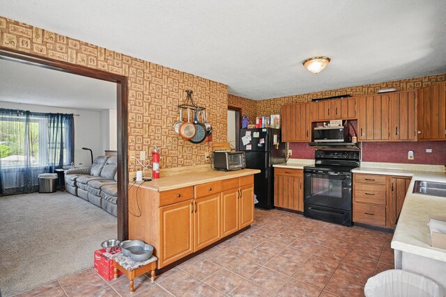 5 Skyline Dr, Chelsea, ME 04330 - kitchen featuring black appliances, light countertops, a sink, open floor plan, and light tile patterned floors