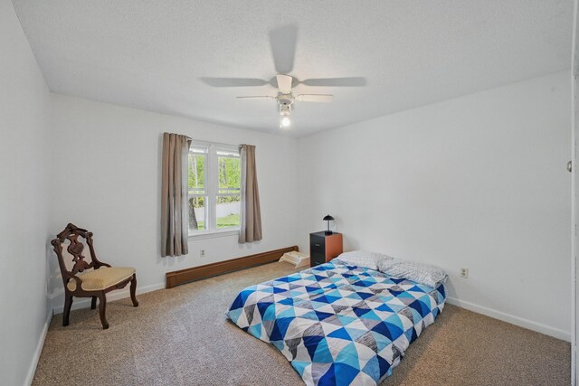 5 Skyline Dr, Chelsea, ME 04330 - carpeted bedroom with baseboard heating, baseboards, ceiling fan, and a textured ceiling