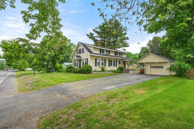 148 Water St, Randolph, ME 04346 - traditional home with a detached garage, a chimney, an outdoor structure, and a front lawn