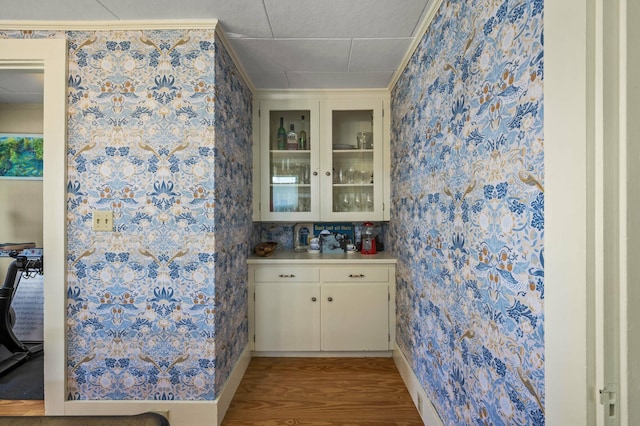 148 Water St, Randolph, ME 04346 - bar with wallpapered walls, light wood finished floors, and ornamental molding