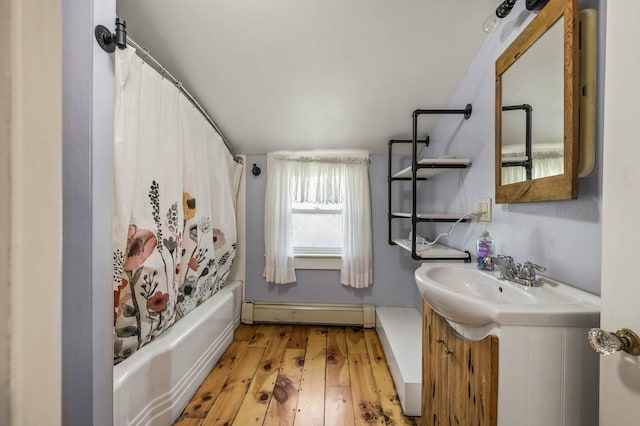 148 Water St, Randolph, ME 04346 - bathroom featuring a baseboard radiator, vanity, hardwood / wood-style flooring, and shower / bath combo with shower curtain