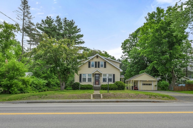148 Water St, Randolph, ME 04346 - view of front facade with a detached garage, driveway, and an outbuilding