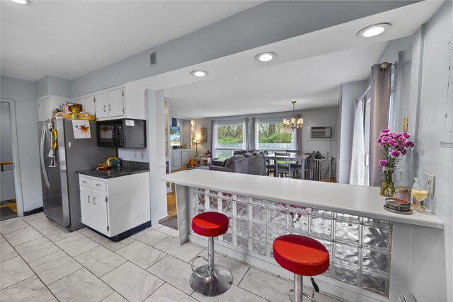 42 Sugarloaf Ln, Bangor, ME 04401 - kitchen with black microwave, white cabinetry, a chandelier, light marble finish flooring, and stainless steel refrigerator with ice dispenser
