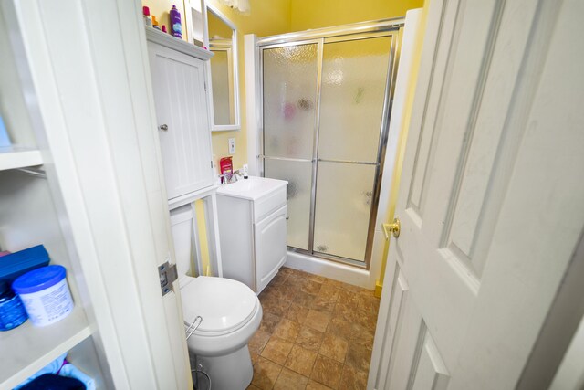 42 Sugarloaf Ln, Bangor, ME 04401 - bathroom with stone finish flooring, a shower stall, toilet, and vanity