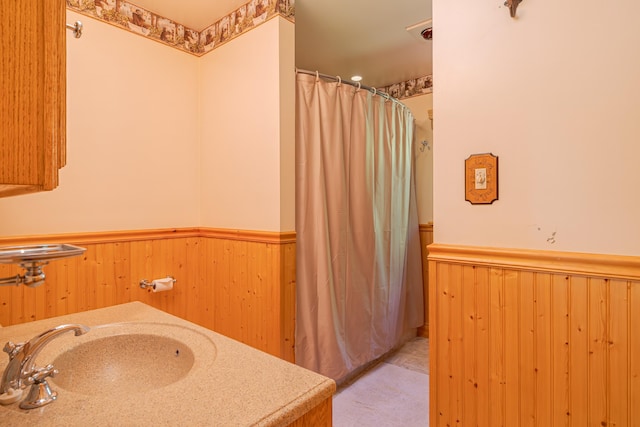 139 Havey Point Rd, Hancock, ME 04640 - full bathroom with wainscoting, a shower with curtain, and wood walls
