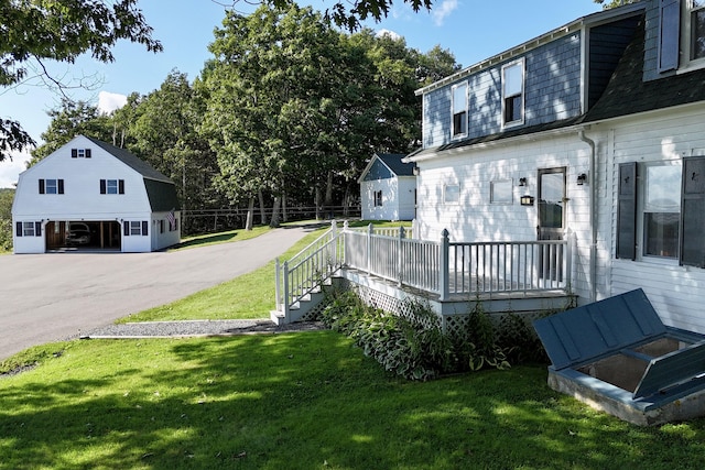 5 Polka Valley Rd, Sedgwick, ME 04676 - view of green lawn with a deck, an outdoor structure, and a detached garage