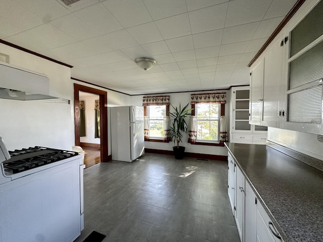 5 Polka Valley Rd, Sedgwick, ME 04676 - kitchen featuring white appliances, white cabinets, dark countertops, exhaust hood, and crown molding