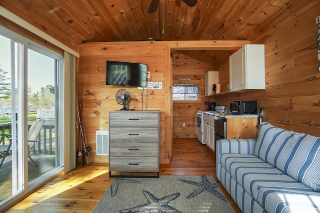 1270 Lakeview Dr Unit 11, China, ME 04358 - living area with light wood finished floors, wooden walls, a ceiling fan, and vaulted ceiling