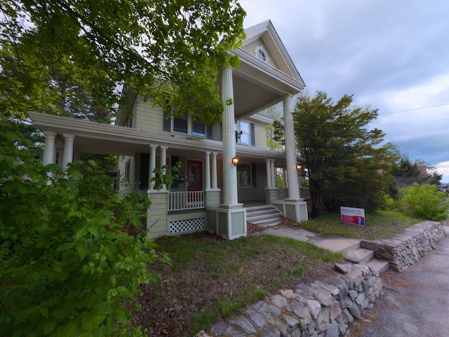 neoclassical / greek revival house featuring covered porch