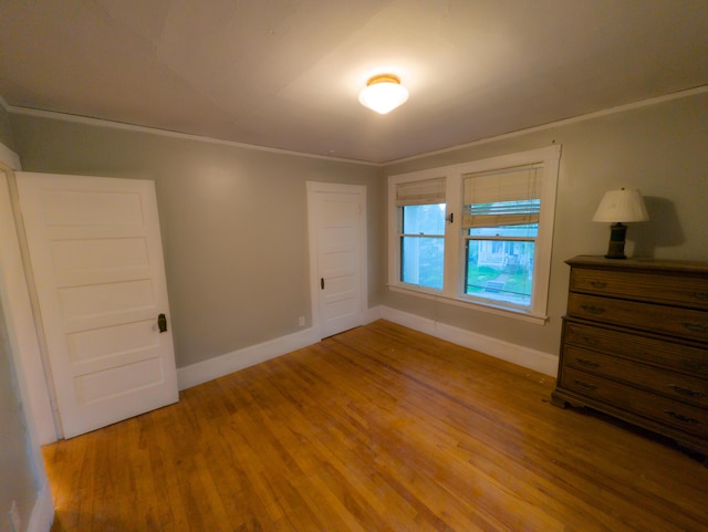 unfurnished bedroom with baseboards and light wood finished floors