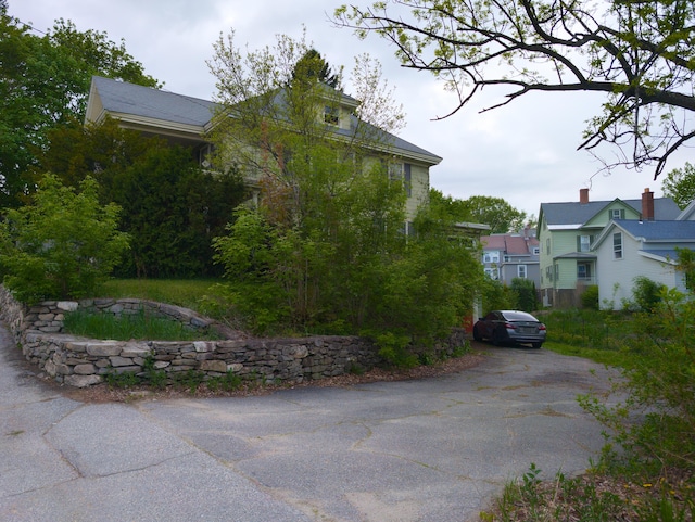 view of property exterior featuring asphalt driveway