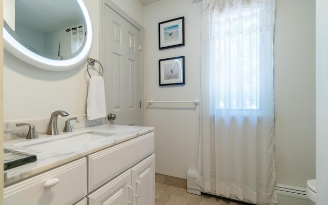 19 Brookside Dr, Falmouth, ME 04105 - full bath featuring toilet, vanity, and baseboard heating