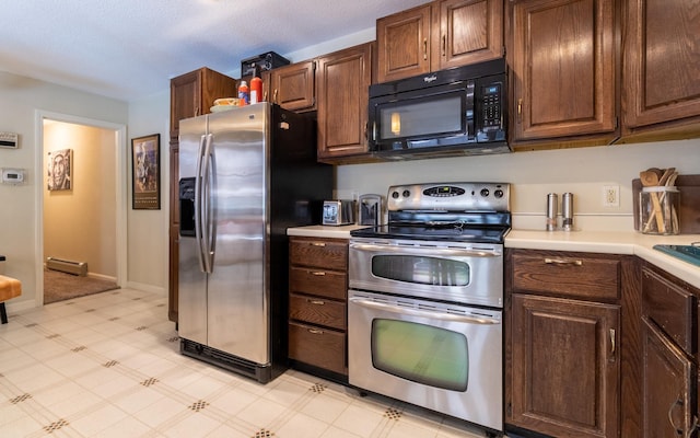 19 Brookside Dr, Falmouth, ME 04105 - kitchen featuring appliances with stainless steel finishes, light countertops, light floors, a baseboard heating unit, and baseboards