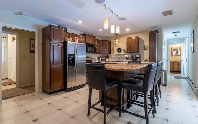 19 Brookside Dr, Falmouth, ME 04105 - kitchen featuring black microwave, stainless steel refrigerator with ice dispenser, recessed lighting, light flooring, and decorative light fixtures