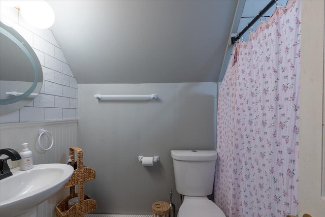 34 Admonten Ave, Rockland, ME 04841 - bathroom featuring vaulted ceiling, a sink, toilet, and a shower with shower curtain