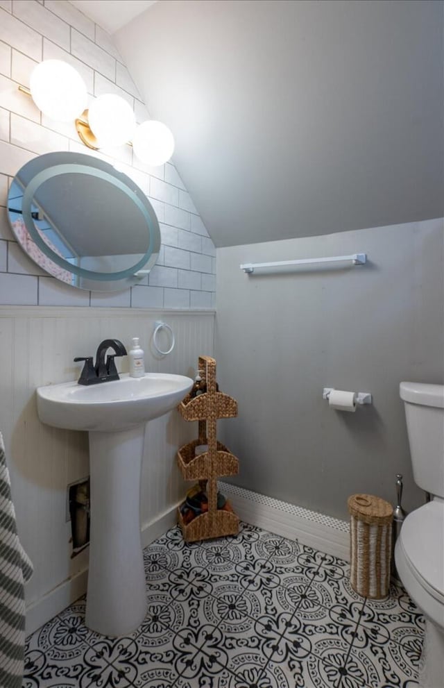 34 Admonten Ave, Rockland, ME 04841 - half bathroom featuring lofted ceiling, toilet, tile patterned floors, baseboards, and a sink