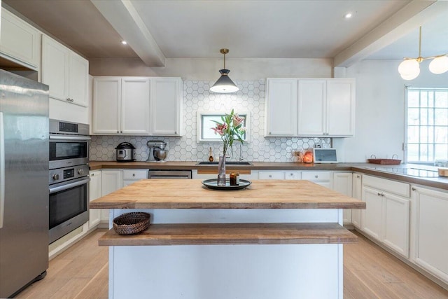 34 Admonten Ave, Rockland, ME 04841 - kitchen featuring appliances with stainless steel finishes, white cabinets, wood counters, light wood-type flooring, and beamed ceiling