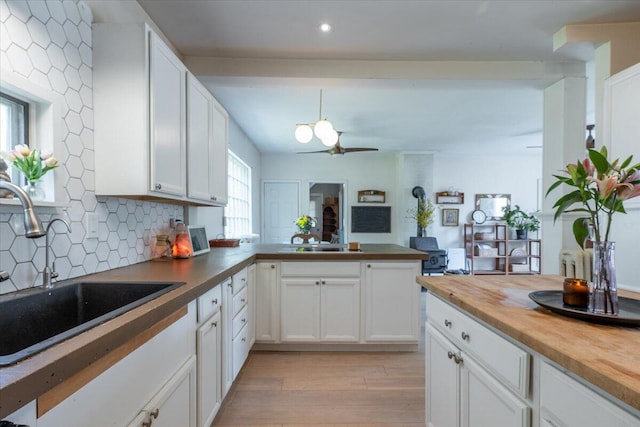 34 Admonten Ave, Rockland, ME 04841 - kitchen with a sink, light wood-style floors, butcher block counters, tasteful backsplash, and white cabinets