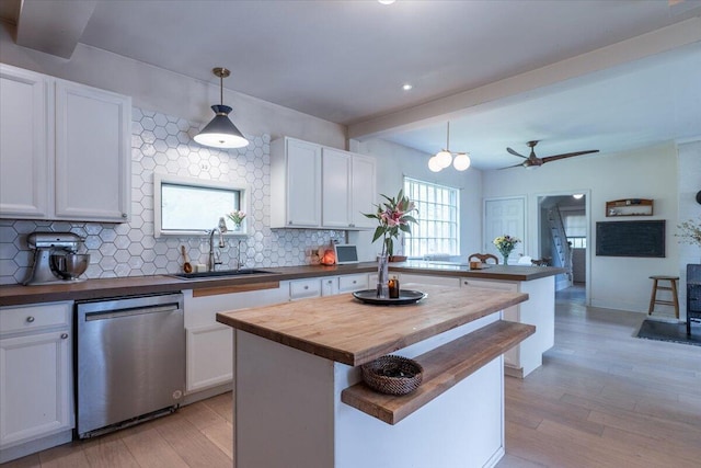 34 Admonten Ave, Rockland, ME 04841 - kitchen featuring stainless steel dishwasher, wooden counters, a sink, light wood finished floors, and recessed lighting