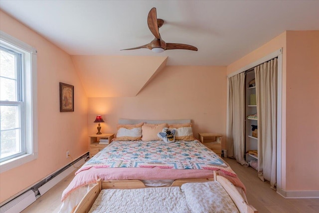 34 Admonten Ave, Rockland, ME 04841 - bedroom featuring a baseboard radiator, baseboards, a ceiling fan, light wood-type flooring, and vaulted ceiling