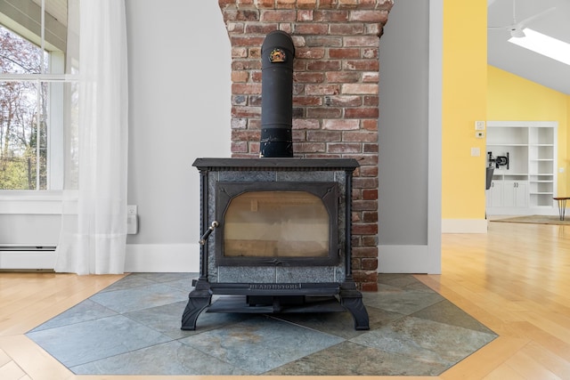 246 Coombs Rd, Brunswick, ME 04011 - detailed view of a wood stove, wood finished floors, and a baseboard radiator