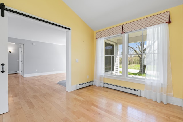 246 Coombs Rd, Brunswick, ME 04011 - spare room featuring baseboard heating, vaulted ceiling, wood finished floors, and a barn door