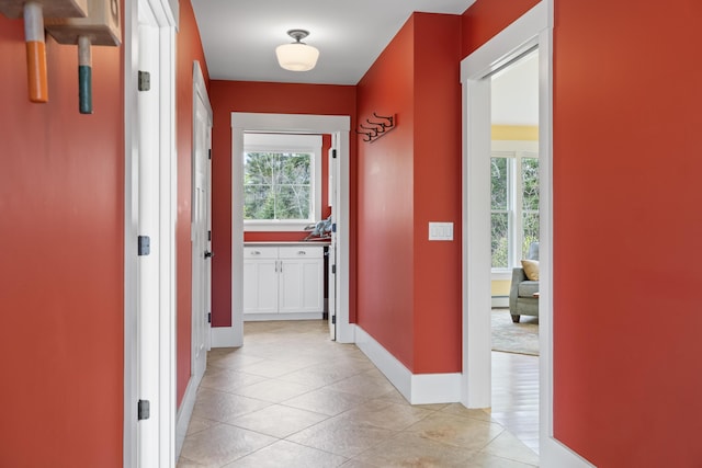 246 Coombs Rd, Brunswick, ME 04011 - hall with plenty of natural light, light tile patterned floors, and baseboards