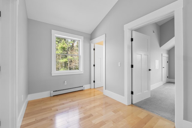 246 Coombs Rd, Brunswick, ME 04011 - unfurnished bedroom with baseboard heating, vaulted ceiling, light wood finished floors, and baseboards
