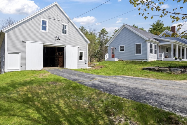 246 Coombs Rd, Brunswick, ME 04011 - view of home's exterior featuring a garage, a yard, a porch, and driveway