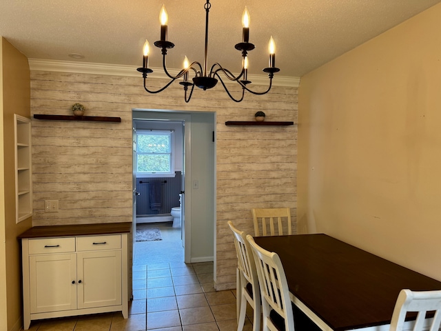 74 Fields Pond Rd, Holden, ME 04429 - dining area with wooden walls, a chandelier, baseboard heating, crown molding, and a textured ceiling