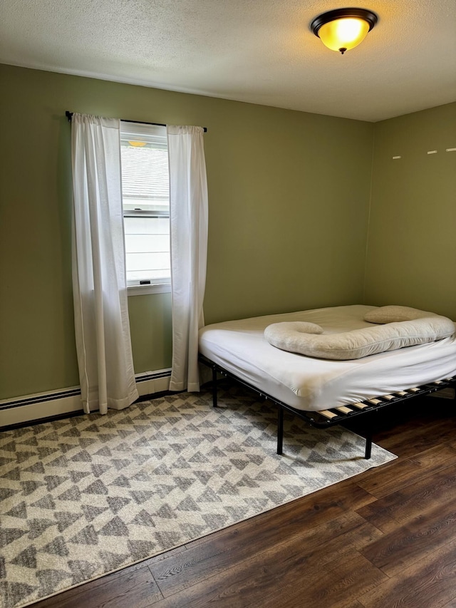 74 Fields Pond Rd, Holden, ME 04429 - bedroom with wood finished floors and a textured ceiling