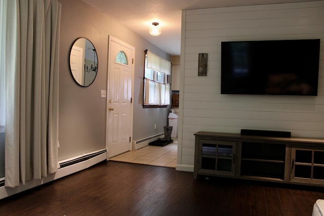 74 Fields Pond Rd, Holden, ME 04429 - entryway featuring a baseboard radiator, wood finished floors, and baseboards