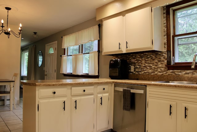 74 Fields Pond Rd, Holden, ME 04429 - kitchen with stainless steel dishwasher, backsplash, white cabinets, a chandelier, and light tile patterned floors
