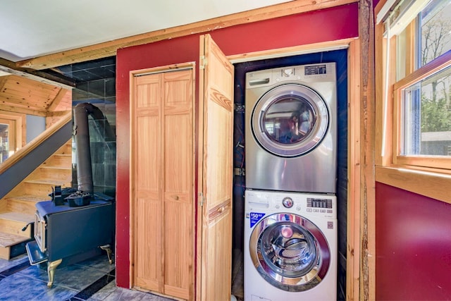 40 Birch Way, Stetson, ME 04488 - laundry room featuring stacked washer / dryer and a wood stove