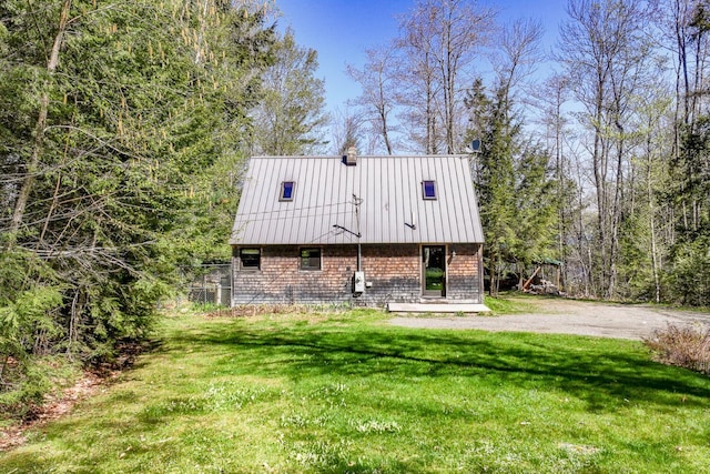 40 Birch Way, Stetson, ME 04488 - view of front of house with a front yard, a standing seam roof, and a metal roof