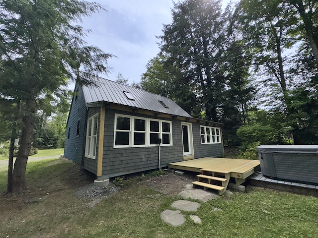40 Birch Way, Stetson, ME 04488 - back of house featuring a wooden deck, a hot tub, and a metal roof