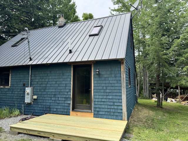 40 Birch Way, Stetson, ME 04488 - back of house featuring a chimney, a metal roof, a standing seam roof, and a lawn