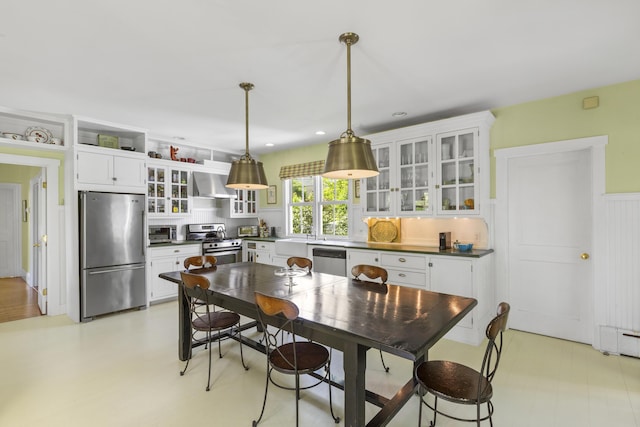 37 Mountain St, Camden, ME 04843 - kitchen featuring stainless steel appliances, wall chimney range hood, dark countertops, and white cabinets