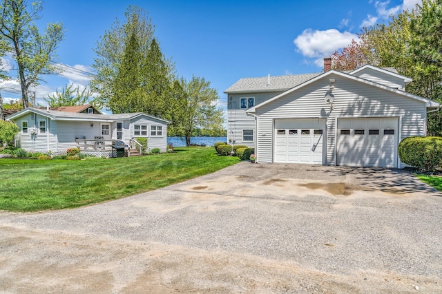 117 Pinkhams Cove Rd, Belgrade, ME 04917 - view of front facade with asphalt driveway, a garage, a chimney, and a front yard