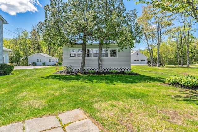 117 Pinkhams Cove Rd, Belgrade, ME 04917 - back of house featuring a garage and a yard