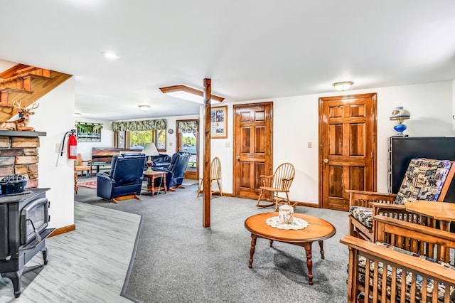 117 Pinkhams Cove Rd, Belgrade, ME 04917 - living room with a wood stove, carpet floors, and baseboards
