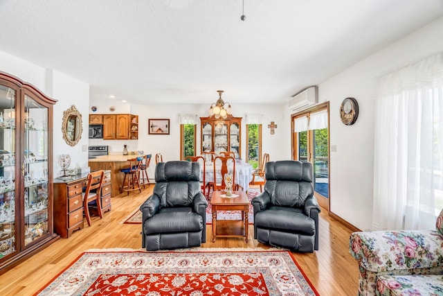 117 Pinkhams Cove Rd, Belgrade, ME 04917 - living area featuring light wood-type flooring and a wall unit AC