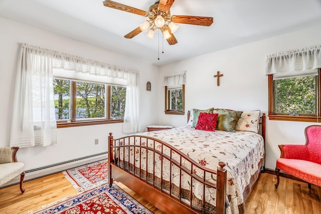 117 Pinkhams Cove Rd, Belgrade, ME 04917 - bedroom featuring wood finished floors, baseboard heating, and a ceiling fan