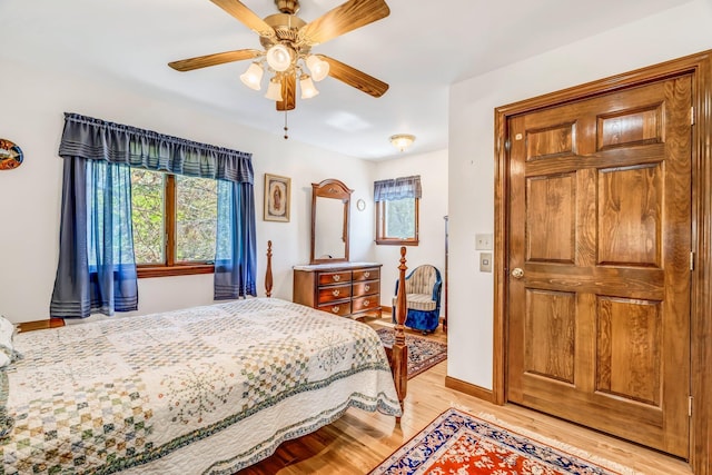 117 Pinkhams Cove Rd, Belgrade, ME 04917 - bedroom with light wood finished floors, multiple windows, baseboards, and ceiling fan