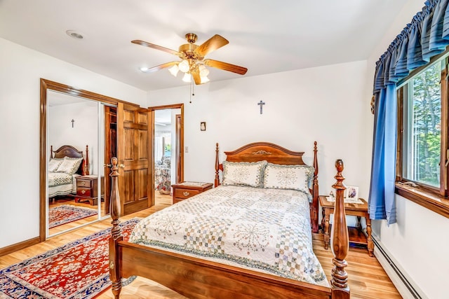 117 Pinkhams Cove Rd, Belgrade, ME 04917 - bedroom featuring baseboard heating, light wood-style floors, ceiling fan, and baseboards