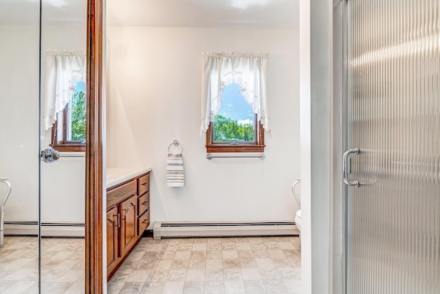 117 Pinkhams Cove Rd, Belgrade, ME 04917 - bathroom with a baseboard radiator, plenty of natural light, vanity, and a stall shower