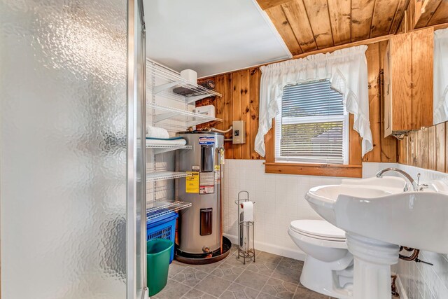 117 Pinkhams Cove Rd, Belgrade, ME 04917 - full bathroom with electric water heater, a stall shower, tile walls, toilet, and tile patterned floors
