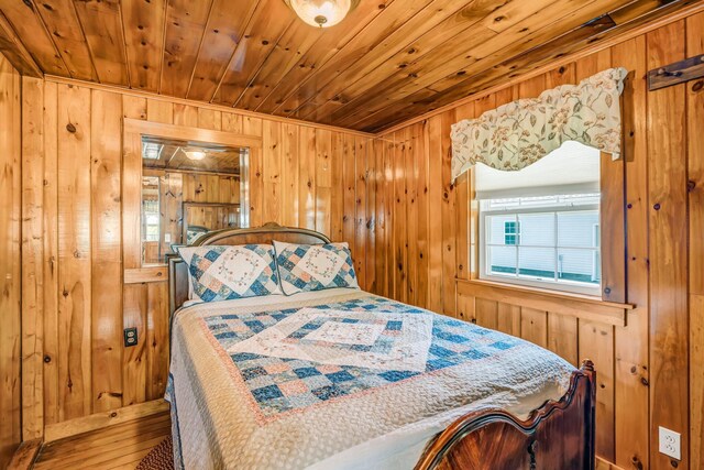 117 Pinkhams Cove Rd, Belgrade, ME 04917 - bedroom featuring wood walls, wooden ceiling, and wood finished floors