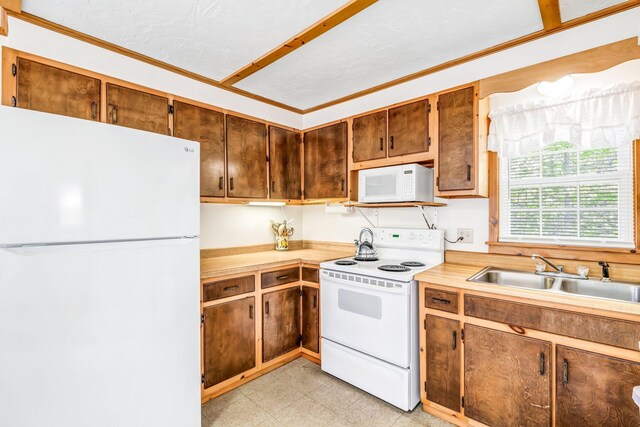 117 Pinkhams Cove Rd, Belgrade, ME 04917 - kitchen with white appliances, a sink, light countertops, light flooring, and crown molding